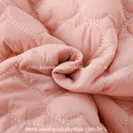 Close do tecido matelassado em formato de corações da jaqueta bebê rosa – Boutique Baby Kids