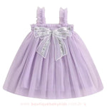 Vestido Infantil Tule Laço de Paetês cor lilás, com tule volumoso e laço brilhante, disponível na Boutique Baby Kids.