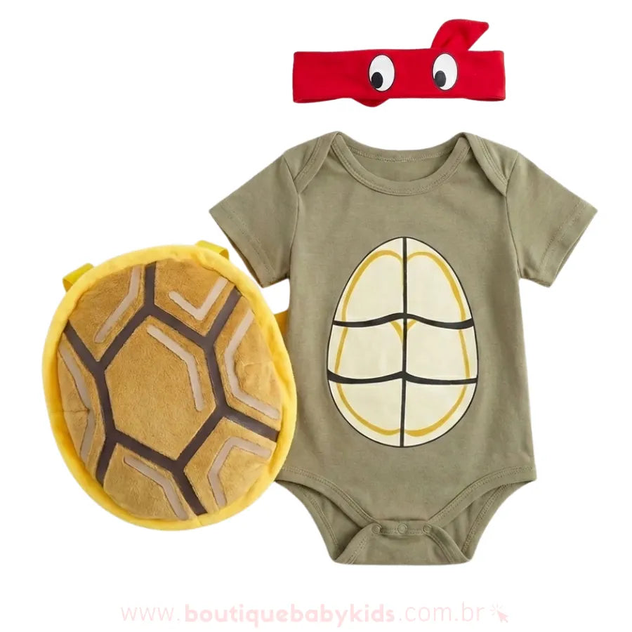 Kit fantasia bebê Tartaruga Ninja completo, composto por body manga curta verde, máscara vermelha e casco de pelúcia removível.