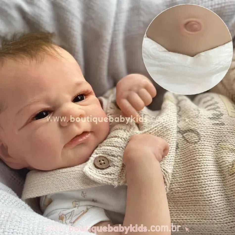 Boneca Bebê Reborn Realista Menino Bryan deitada com jardineira bege e detalhe ampliado do umbigo. - Boutique Baby Kids