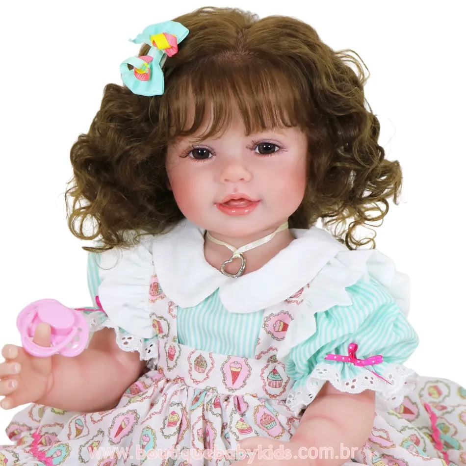 Boneca Bebê Reborn Maria sorrindo, com cabelo solto cacheado e laço azul com detalhes coloridos.