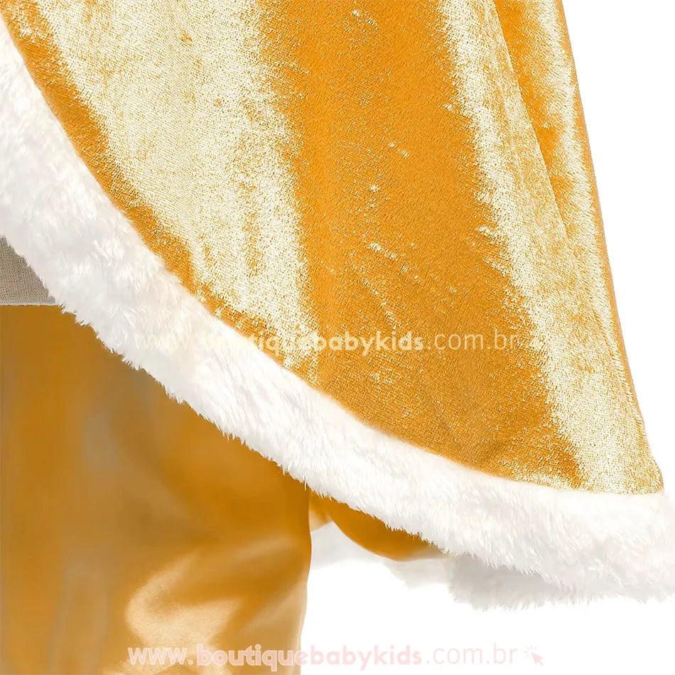 Detalhe do capuz da capa dourada, feito em tecido brilhante e contornado com pelúcia branca para um toque sofisticado. 