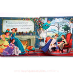 Página do livro pop-up mostrando o príncipe ajoelhado ao lado de Cinderela, tentando encaixar o sapatinho de cristal em seu pé. As meias-irmãs observam a cena, enquanto o ambiente luxuoso é decorado com móveis clássicos e um lindo vitral ao fundo.
