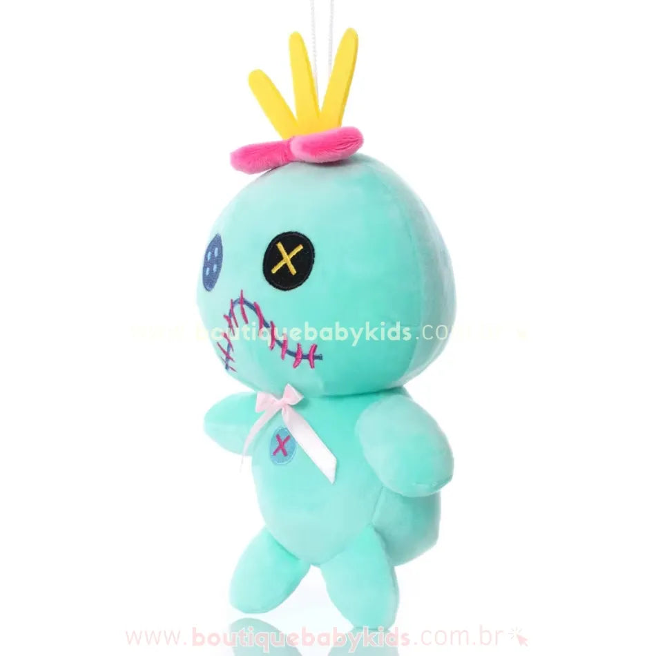 Pelúcia Scrump da Lilo vista de lado, com coroa amarela, laço rosa e fio para pendurar, sobre fundo branco.