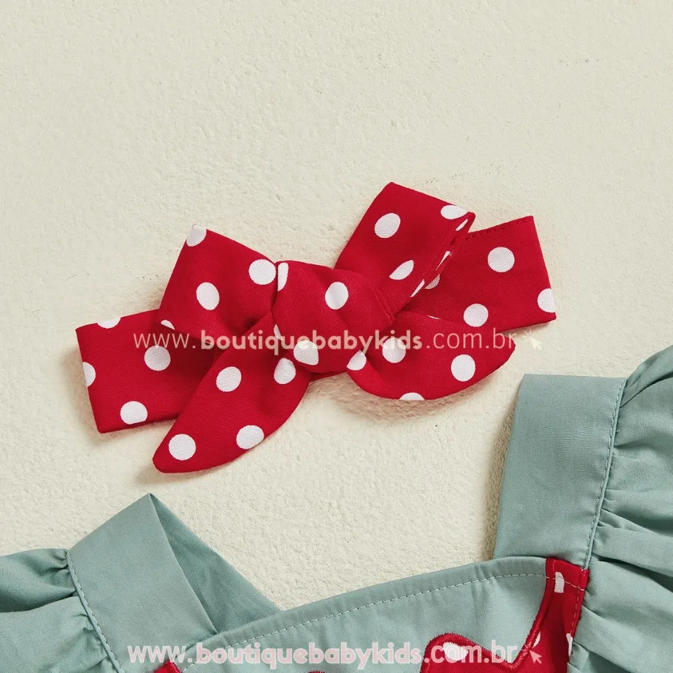 Faixa vermelha com poás brancos em laço duplo que acompanha o romper