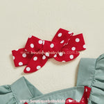 Faixa vermelha com poás brancos em laço duplo que acompanha o romper