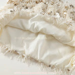 Detalhe interno da barra do vestido Belle Plume, exibindo o forro acetinado confortável e a qualidade da costura das plumas.