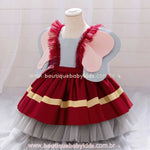 Vestido temático do Dumbo em exibição lateral, com alças decoradas com babados em tule vermelho e grandes orelhas fixas nas laterais.